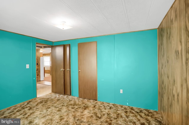 unfurnished bedroom with carpet floors and a textured ceiling