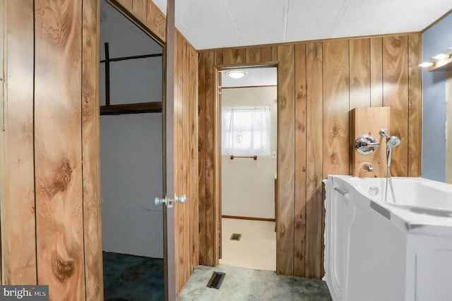 laundry room featuring wood walls