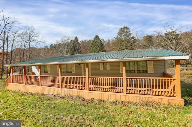 rear view of house featuring a porch