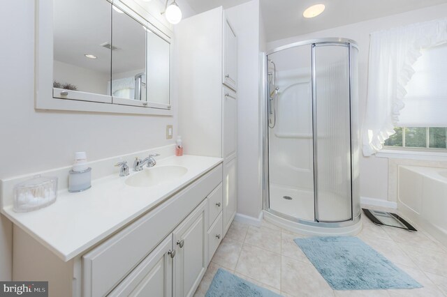 bathroom featuring walk in shower, tile patterned flooring, and vanity