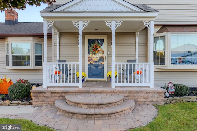 doorway to property featuring covered porch