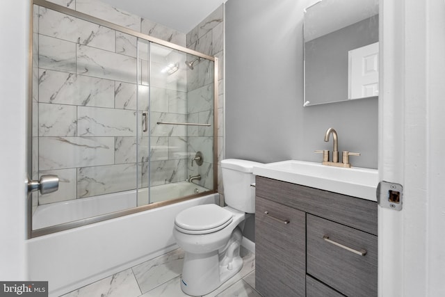 full bathroom featuring toilet, combined bath / shower with glass door, and vanity