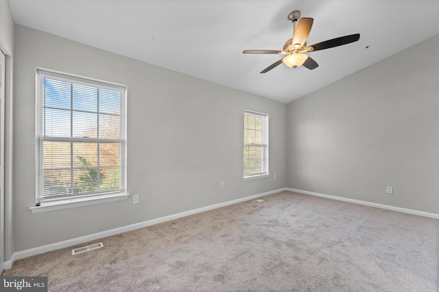 carpeted empty room with ceiling fan and vaulted ceiling