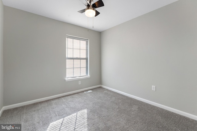 carpeted spare room with ceiling fan