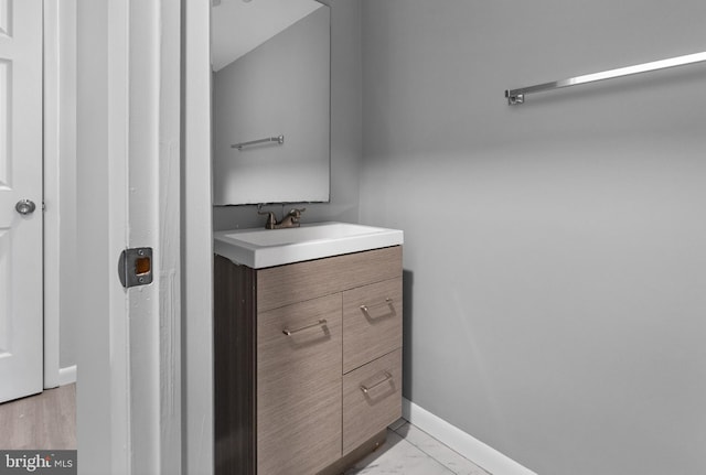 bathroom with hardwood / wood-style floors and vanity