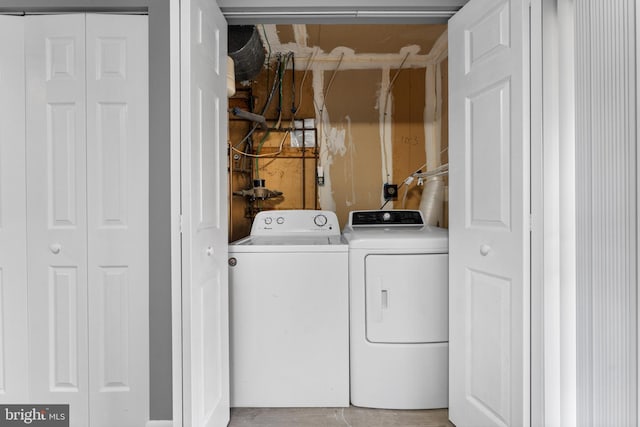 washroom featuring washer and clothes dryer