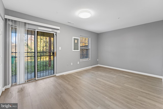 unfurnished room with light wood-type flooring