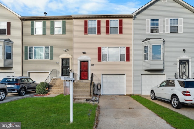 view of property featuring a garage and a front yard