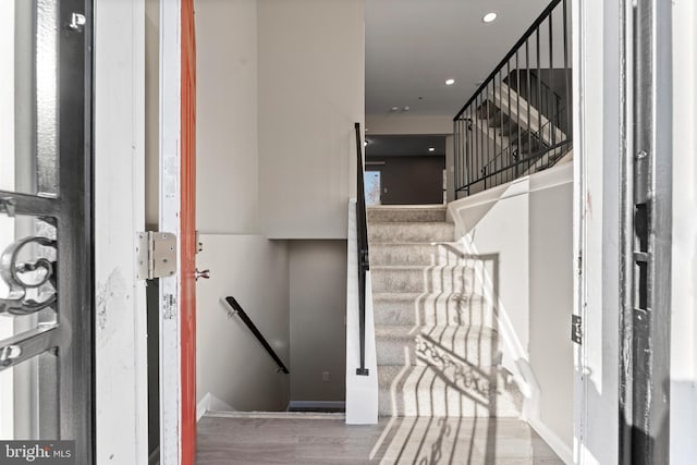 staircase with wood-type flooring