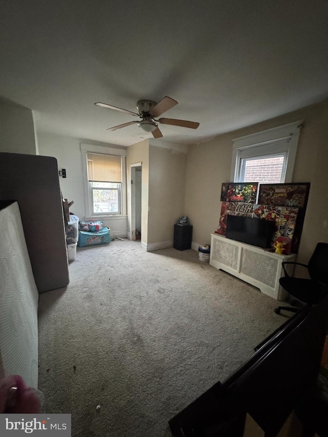 carpeted living room featuring ceiling fan