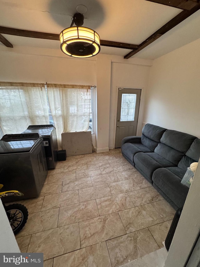 living room featuring washing machine and dryer, ceiling fan, and beamed ceiling