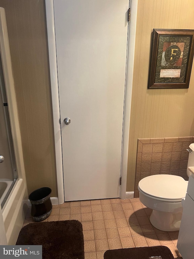 bathroom with toilet, vanity, and tile patterned floors