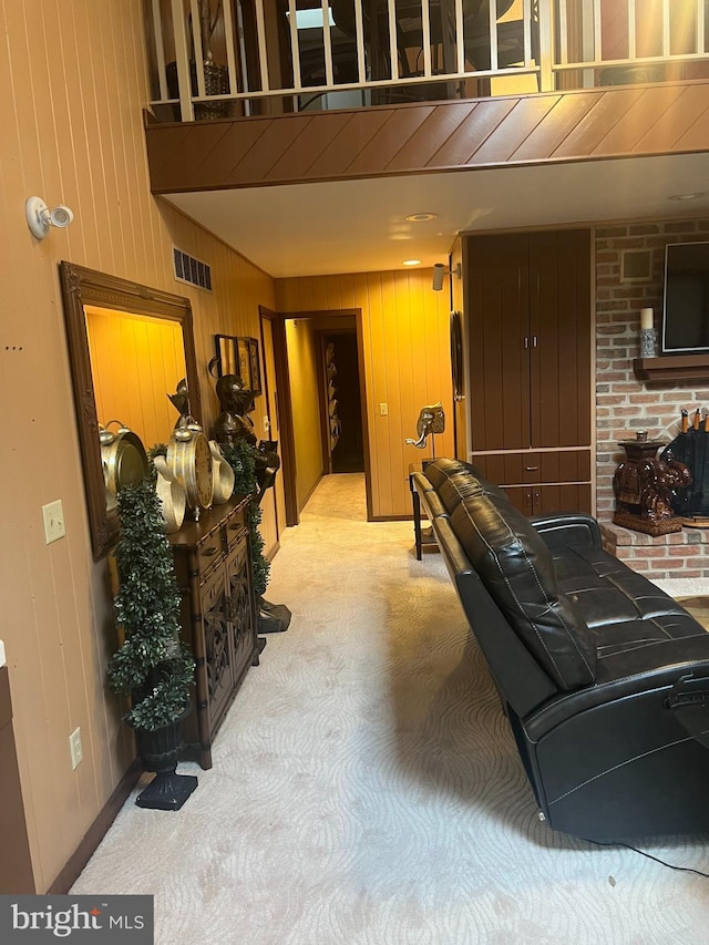 recreation room with wood walls and light carpet