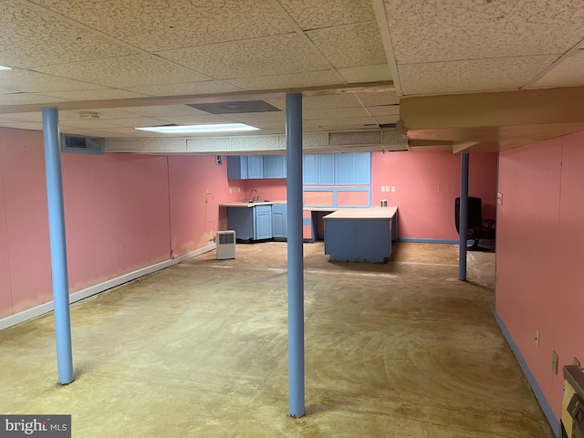 basement with sink and a drop ceiling