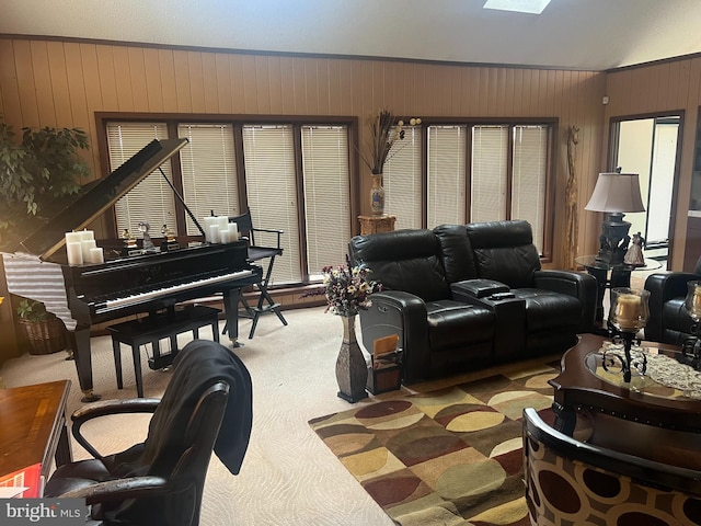 carpeted living room with wooden walls and vaulted ceiling