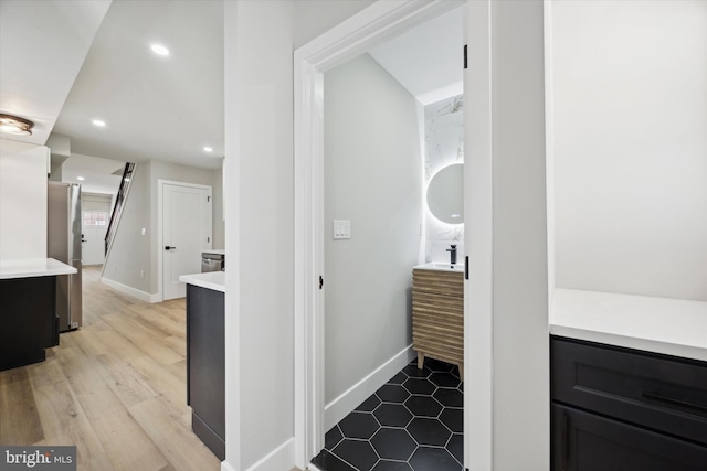 bathroom featuring hardwood / wood-style flooring and vanity