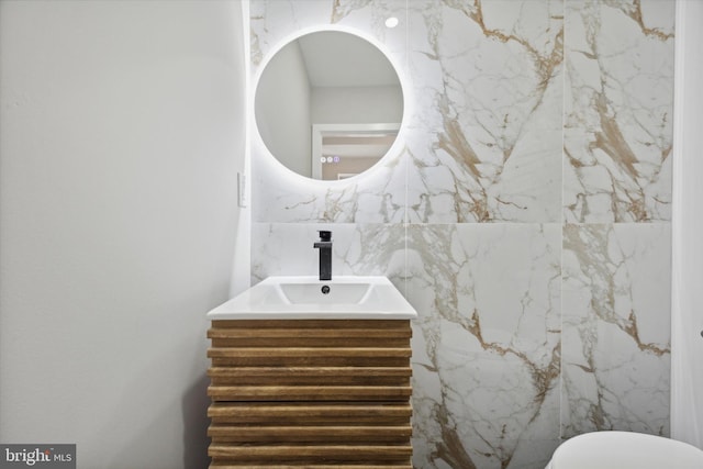 bathroom with tile walls and vanity