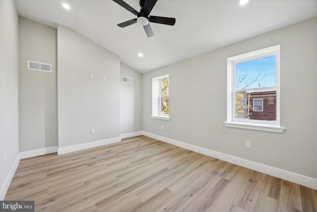 unfurnished room with lofted ceiling, ceiling fan, and light hardwood / wood-style flooring