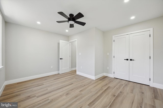 unfurnished bedroom featuring light hardwood / wood-style floors, ceiling fan, and a closet