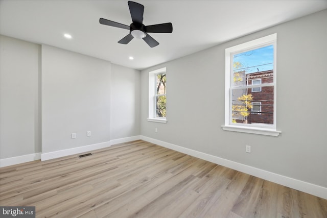 spare room with light hardwood / wood-style floors and ceiling fan