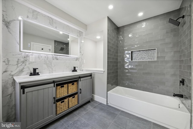 bathroom featuring tile walls, tiled shower / bath combo, and vanity