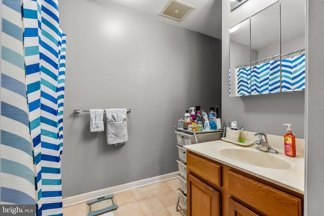 bathroom with tile patterned floors and vanity