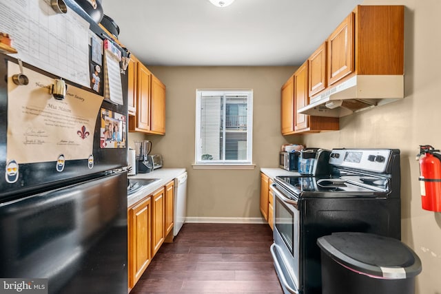 kitchen featuring stainless steel appliances, dark wood-type flooring, and sink