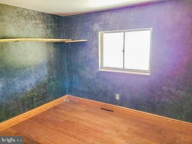 spare room featuring hardwood / wood-style flooring