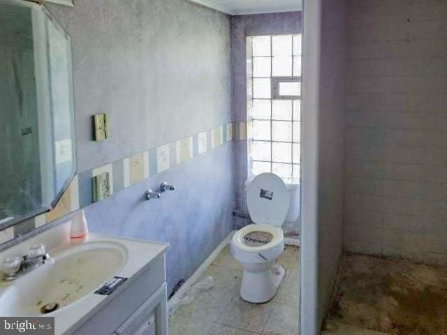 bathroom with vanity, tile patterned floors, and toilet