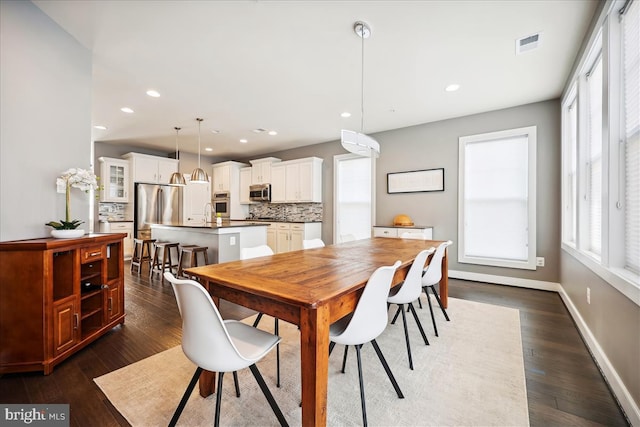 dining space with dark wood-type flooring