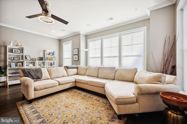 living room featuring ornamental molding, plenty of natural light, dark wood-type flooring, and ceiling fan