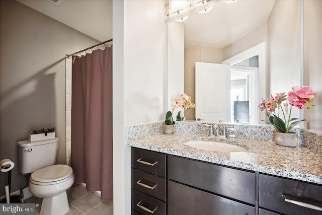 bathroom with tile patterned flooring, a shower with curtain, vanity, and toilet