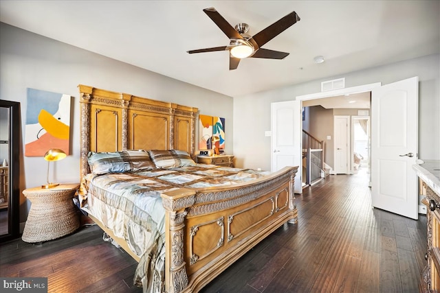 bedroom with ceiling fan and dark hardwood / wood-style floors