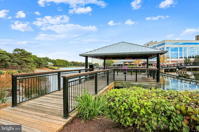 view of dock with a gazebo and a water view