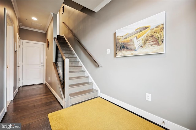 stairs featuring hardwood / wood-style floors and ornamental molding