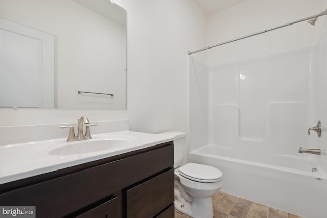 full bathroom featuring vanity, bathing tub / shower combination, and toilet