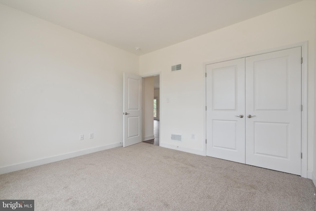 unfurnished bedroom featuring a closet and carpet flooring