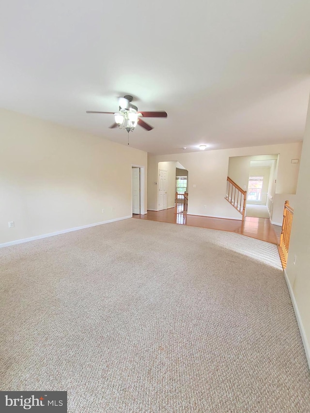 carpeted empty room featuring ceiling fan