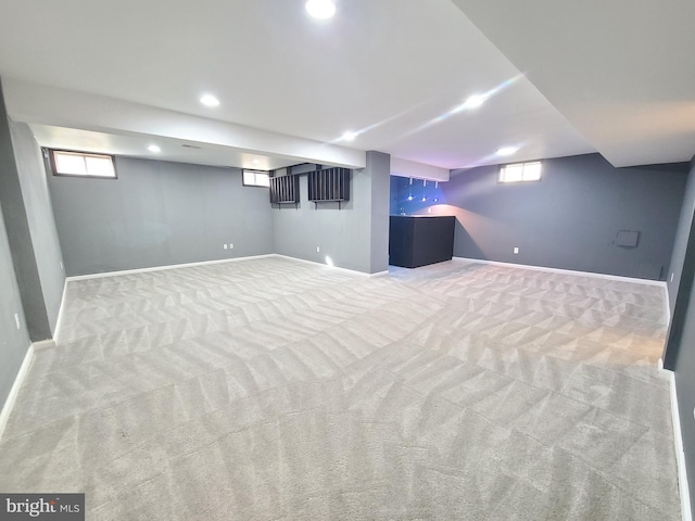 basement with plenty of natural light and carpet flooring