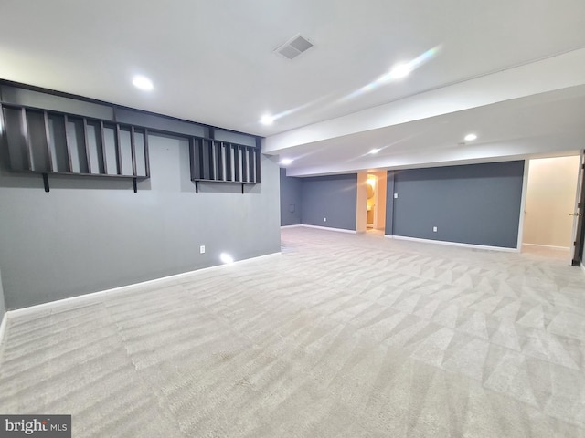 basement featuring light carpet