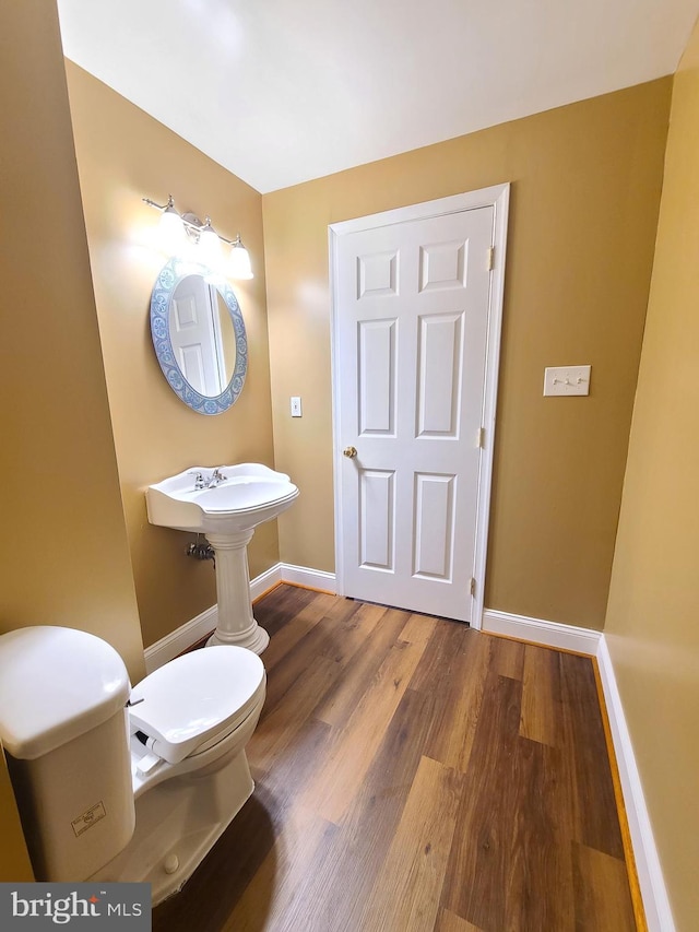 bathroom featuring hardwood / wood-style floors and toilet