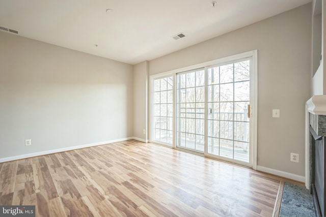 unfurnished room with light hardwood / wood-style floors