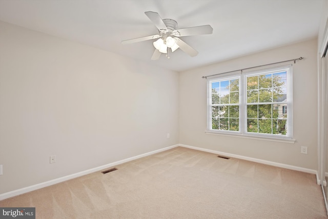 empty room with light carpet and ceiling fan