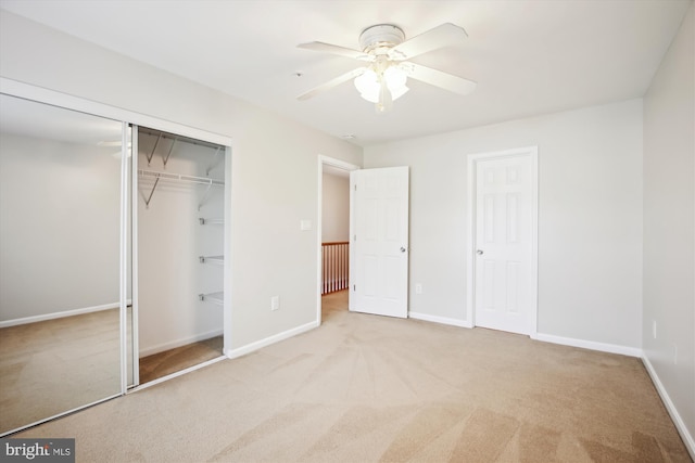 unfurnished bedroom featuring light carpet and ceiling fan