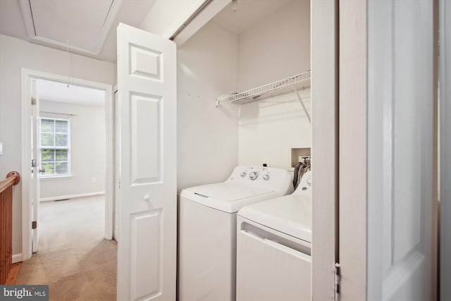 clothes washing area featuring separate washer and dryer and light colored carpet