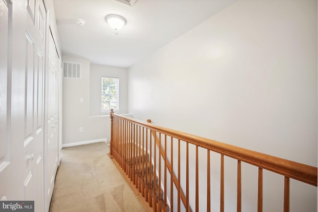 hallway with light colored carpet