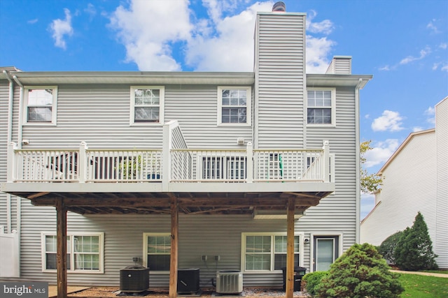 rear view of property with central air condition unit and a wooden deck