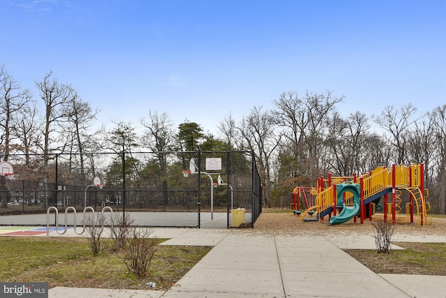 view of basketball court featuring a playground