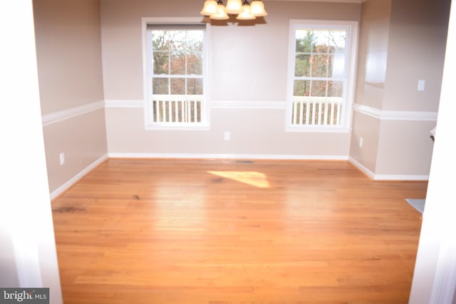 531 Washout Ln, Winchester, VA 22603 - unfurnished dining area with a notable chandelier, baseboards, and light wood-style floors