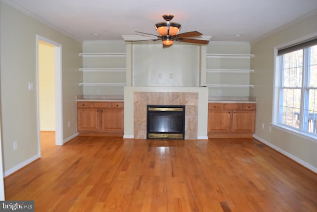 531 Washout Ln, Winchester, VA 22603 - unfurnished living room featuring a ceiling fan, light wood-style floors, a tiled fireplace, and ornamental molding